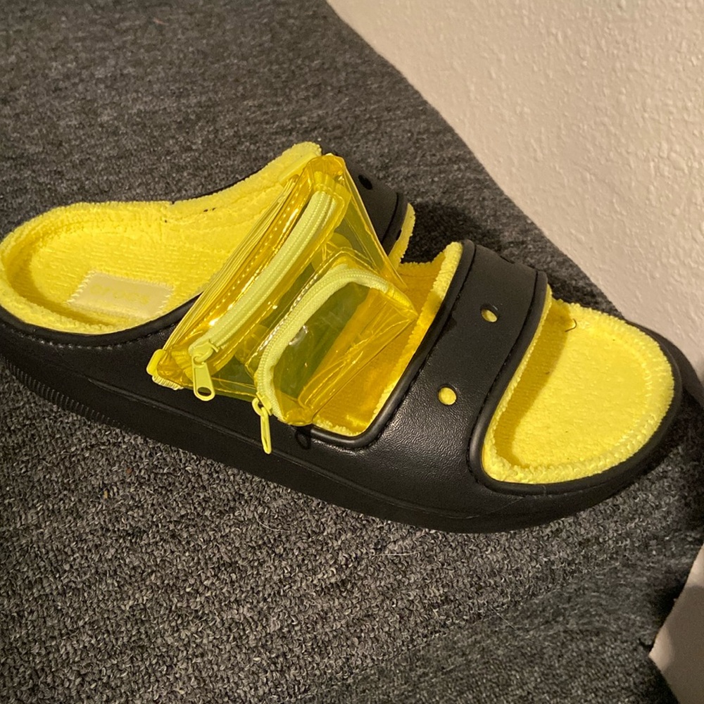 Crocs, black with yellow and small backpack on each shoe